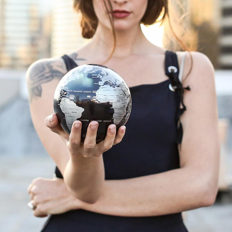Black and Silver Mova Globe 4.5 inch in hand