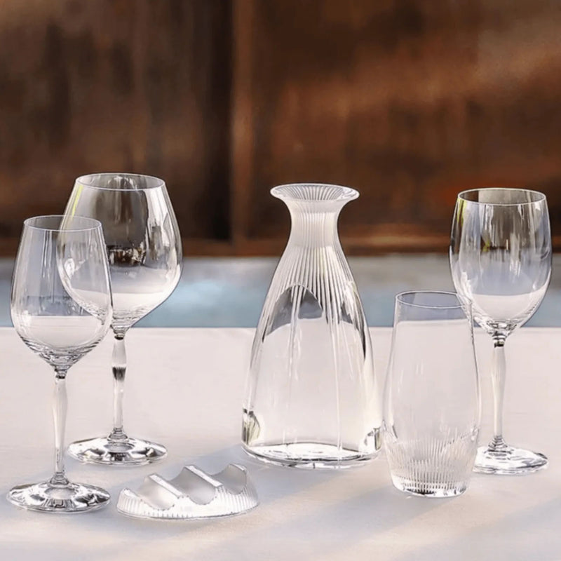 Clear stemmed wine glass with rounded bowl, shown among matching glassware on table