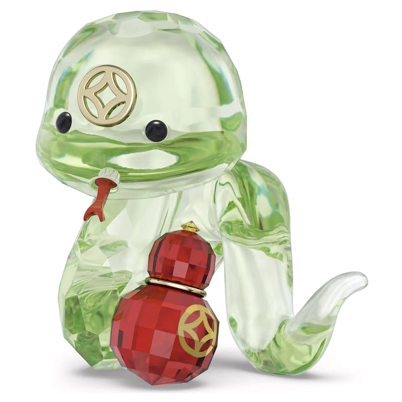Swarovski green crystal snake figurine with a red and gold bottle