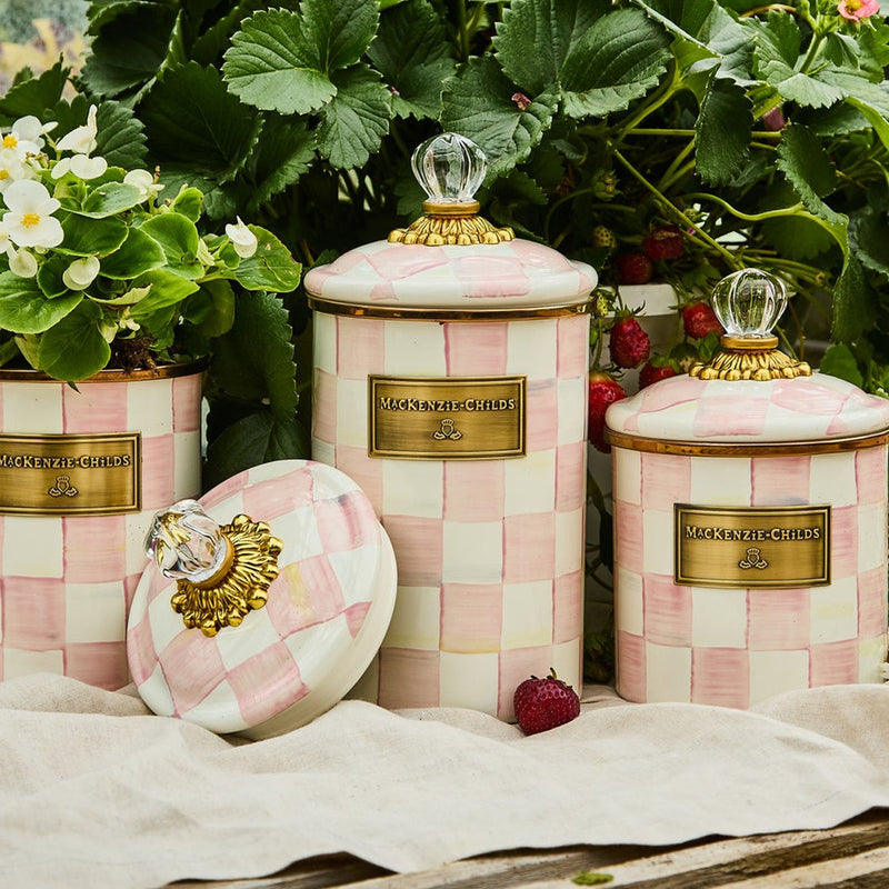 Pink check ceramic storage canister with gold nameplate and knobbed lid
