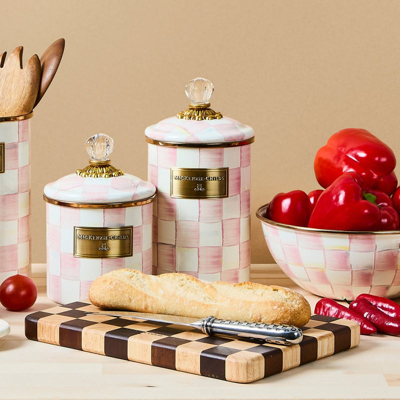 Stacked ceramic canisters with pink check pattern, gold lid knobs, and gold nameplate