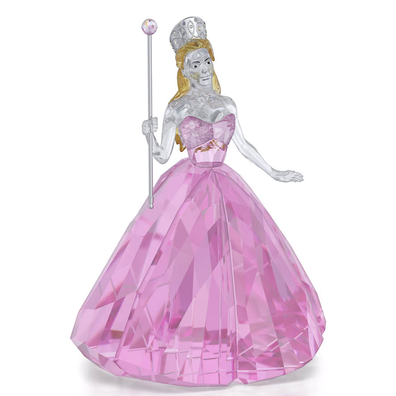 Crystal figure of a princess in a pink gown with a tiara and wand on a white background