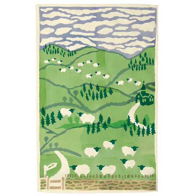Tea towel with green landscape, sheep silhouettes and blue wave sky