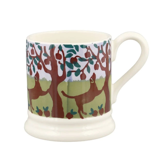 Half-pint ceramic mug, white with red and green orchard pattern, with curved handle