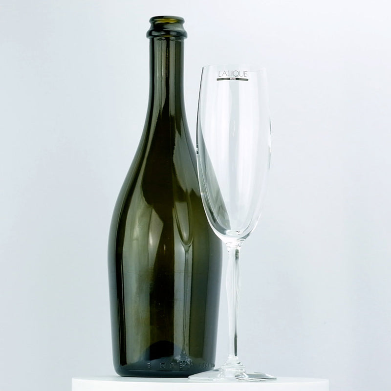 Lalique 100 Points Champagne Glass displayed with a champagne bottle