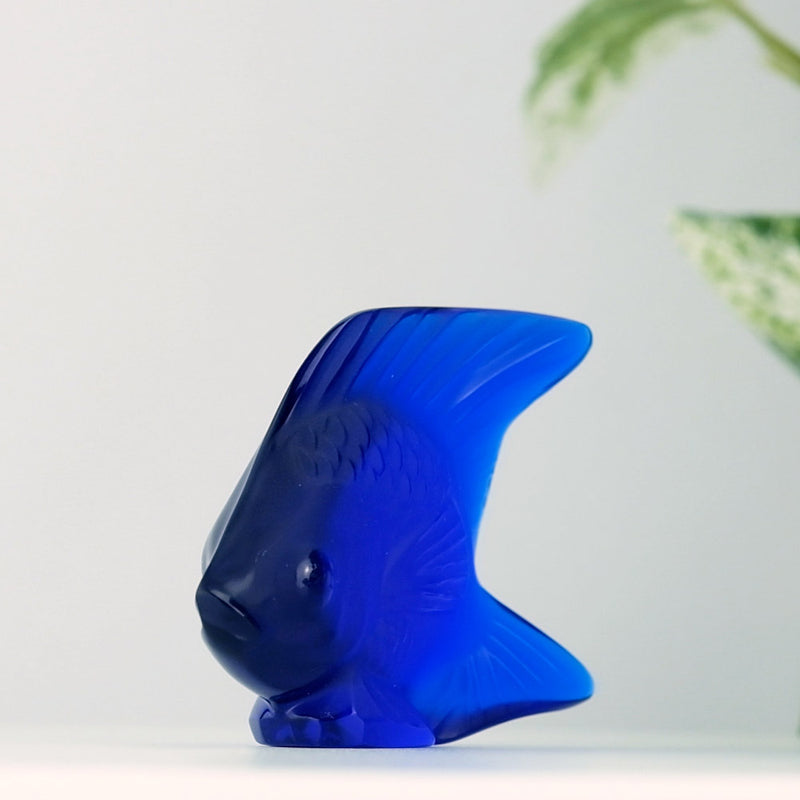 Lalique Cap Ferrat Blue Fish with a plant in the background