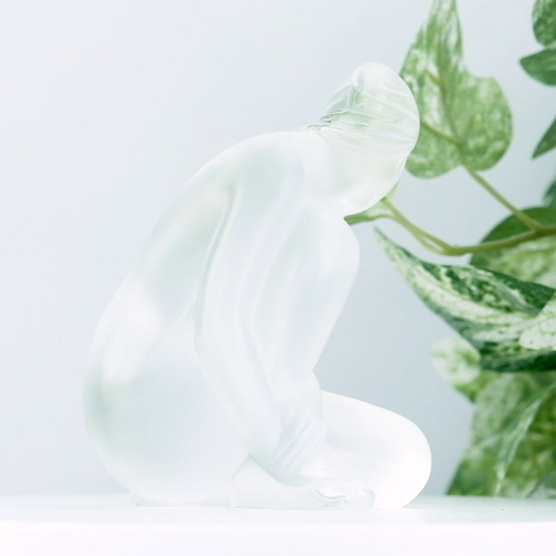 Lalique Clear Nude Venus with a plant in the background