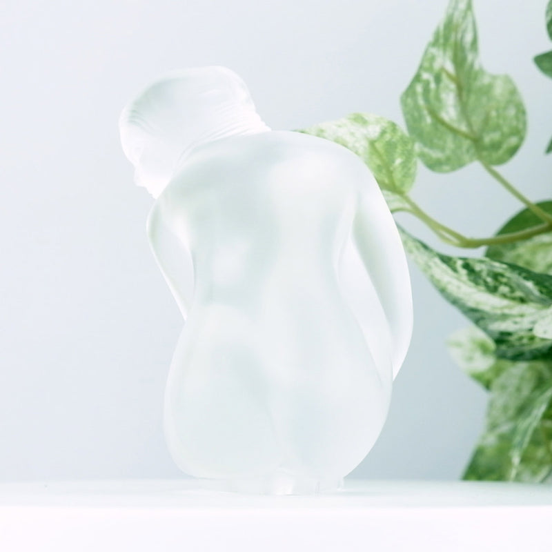 Lalique Clear Nude Venus with a plant in the background