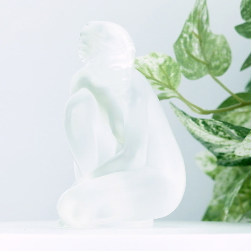 Lalique Clear Nude Venus with a plant in the background