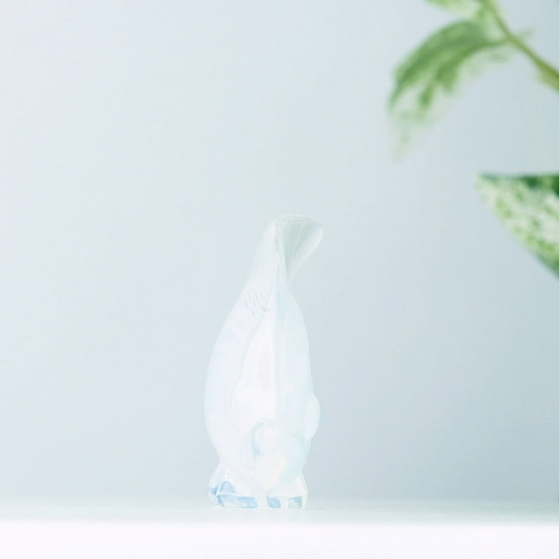Lalique Opalescent Fish with plants in the background