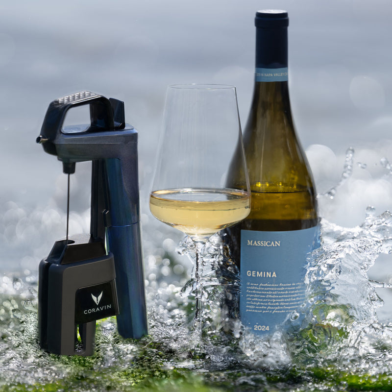 Coravin Timeless Six+ wine preservation device beside a bottle and glass of white wine