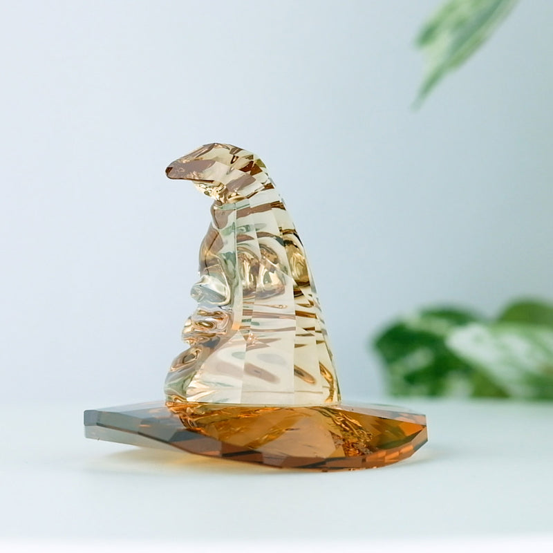 Swarovski Harry Potter Sorting Hat with a plant in the background