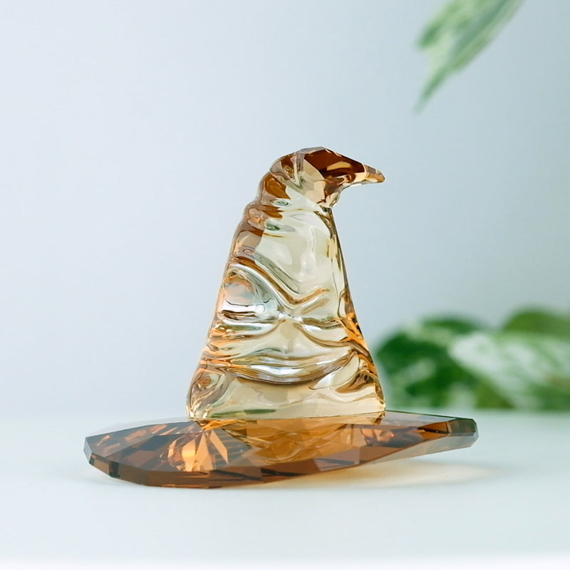 Swarovski Harry Potter Sorting Hat with a plant in the background